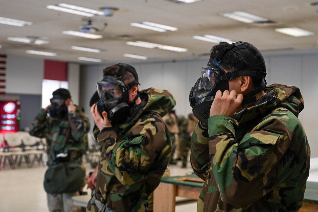 U.S. Airmen assigned to the 354th Logistics Readiness Squadron don gas masks during an expeditionary training week at Eielson Air Force Base, Alaska, Feb. 11, 2025.