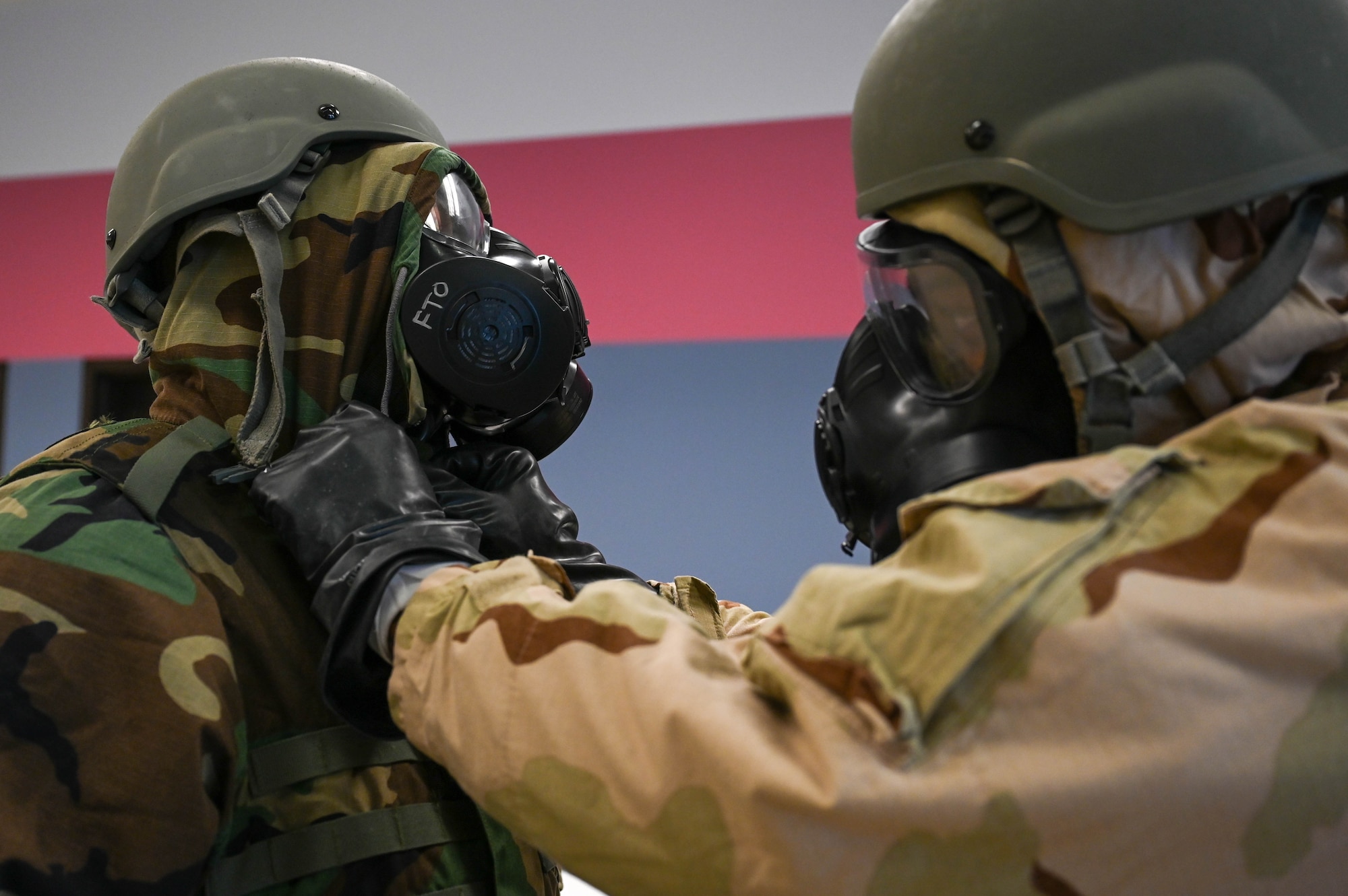 U.S. Airmen assigned to the 354th Logistics Readiness Squadron check each other’s Mission Oriented Protective Posture gear during the expeditionary training week at Eielson Air Force Base, Alaska, Feb. 11, 2025.