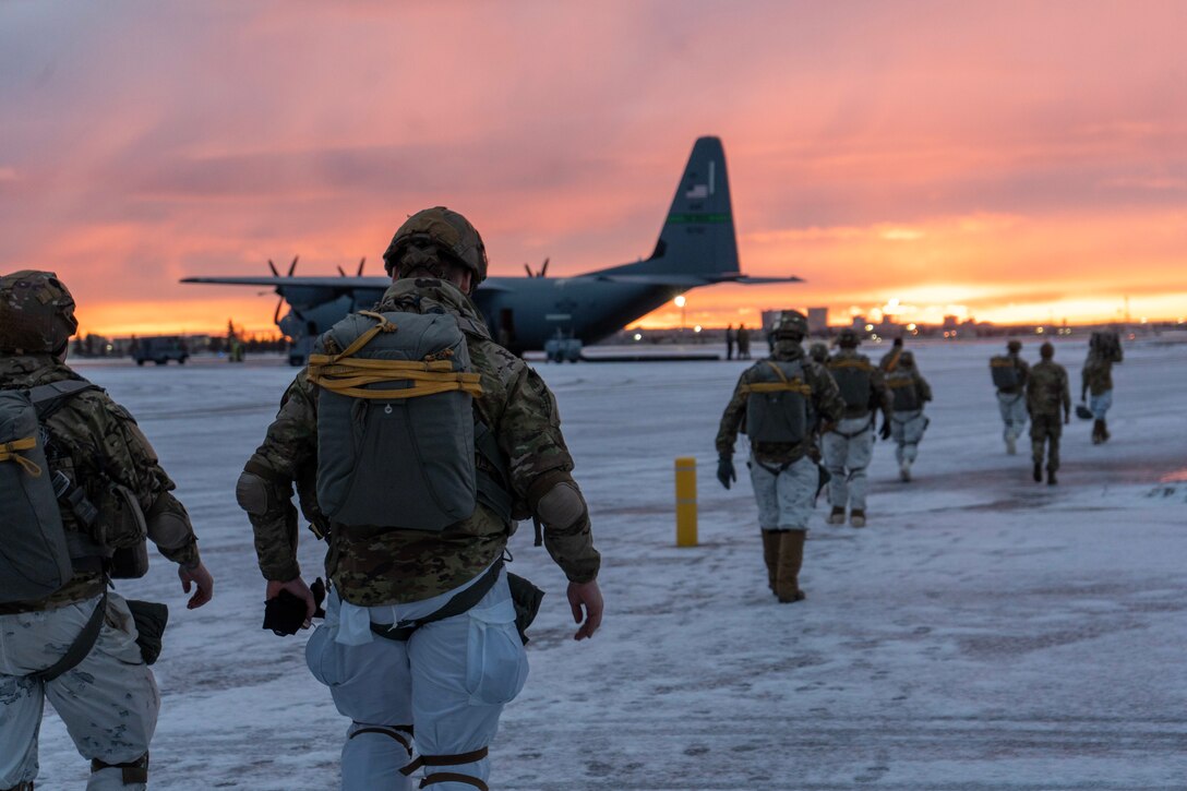 Soldiers from 2nd Infantry Brigade Combat Team (Airborne), 11th Airborne Division head on to the tarmac before loading on to the C-130s in preparation of a Joint Forcible Entry Operation at the start of Joint Pacific Multinational Readiness Center 25-02, at Joint Base Elmendorf-Richardson, Alaska, Jan. 22, 2025.