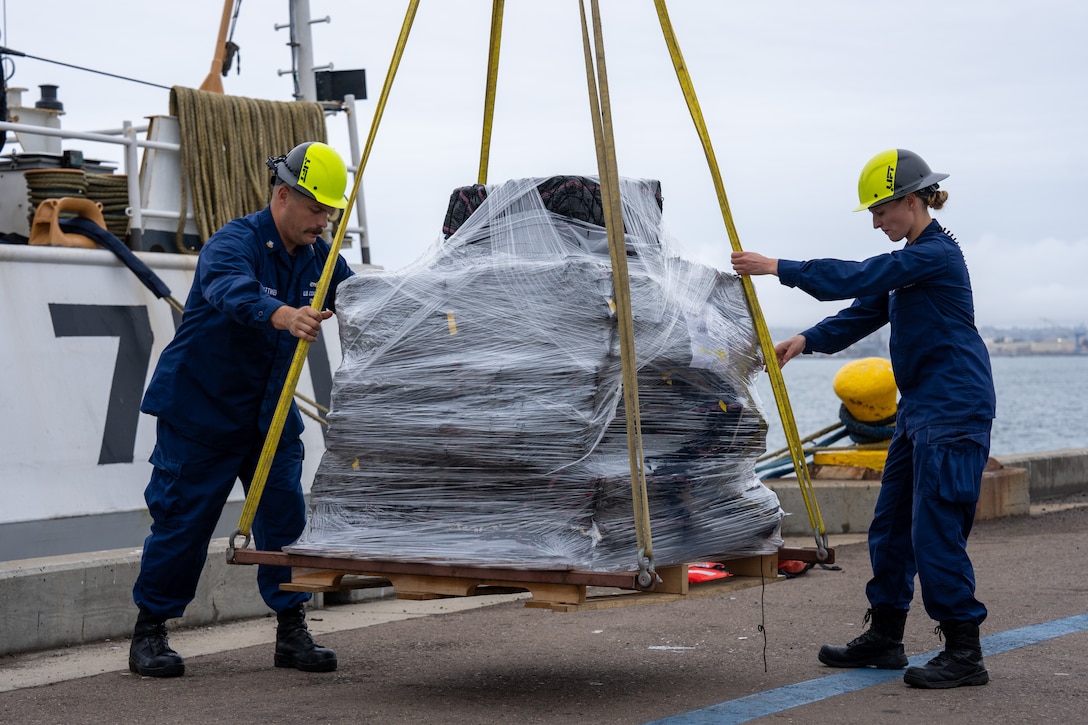 U.S. Coast Guard Cutter Waesche (WMSL 751) crewmembers offload bales of seized narcotics in San Diego, Feb. 13, 2025. The drugs, worth an estimated $275 million, were seized in international waters of the Eastern Pacific Ocean. (U.S. Coast Guard photo by Petty Officer 3rd Christopher Sappey)