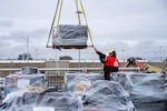 U.S. Coast Guard Cutter Waesche (WMSL 751) crewmembers offload bales of seized narcotics in San Diego, Feb. 13, 2025. The drugs, worth an estimated $275 million, were seized in international waters of the Eastern Pacific Ocean. (U.S. Coast Guard photo by Petty Officer 3rd Christopher Sappey)