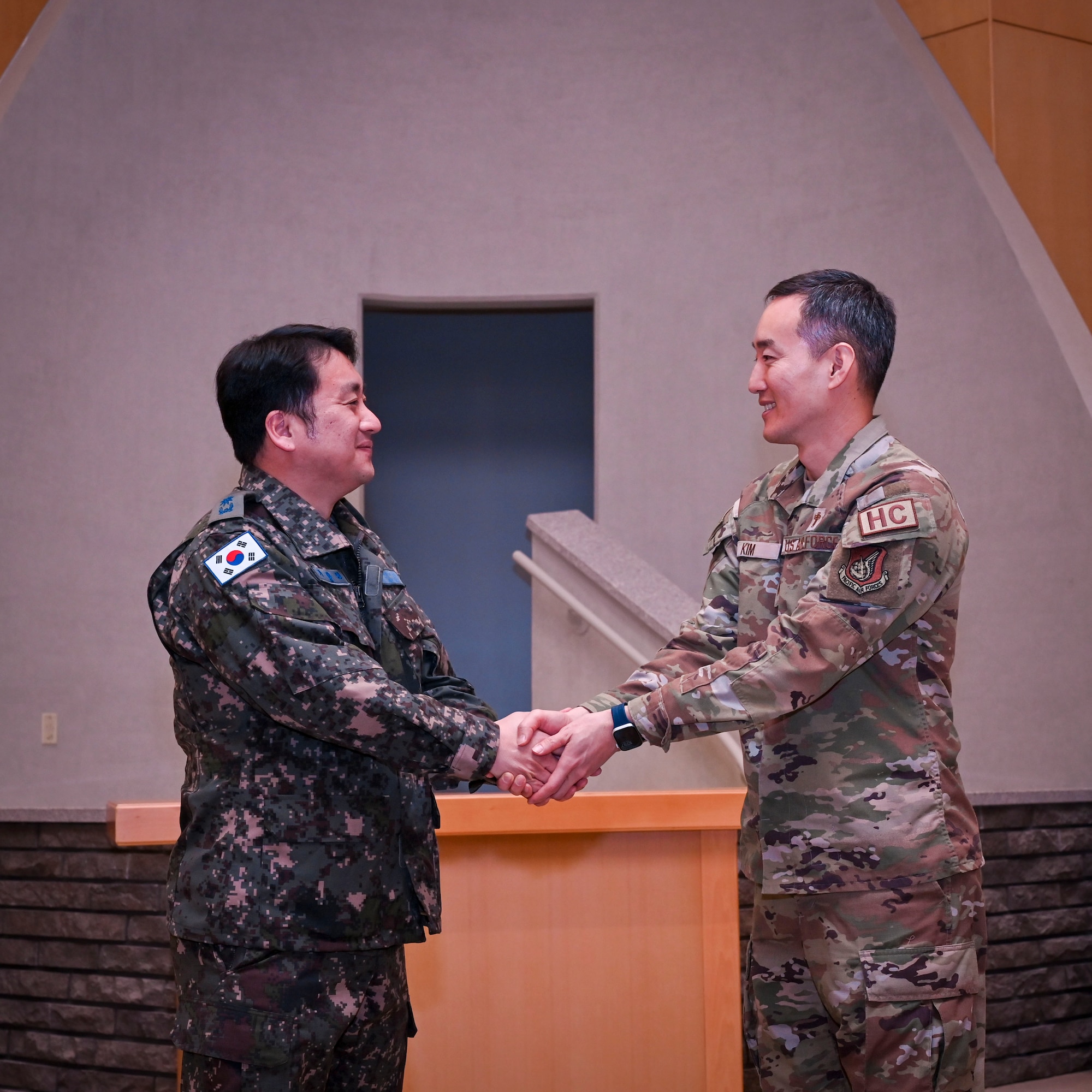 U.S. Air Force Capt. Bermsoo Kim, 51st Fighter Wing chaplain, shakes hands with Maj. Ka Kwang-Myeong, Republic of Korea Air Force Operations Command head chaplain at Osan Air Base, Republic of Korea, Jan. 22, 2025. In 2024, Kim was accepted into the Language Enabled Airman Program allowing him to utilize his skills to strengthen partnership and cooperation with the ROK. (U.S. Air Force photo by Senior Airman Sabrina Fuller-Judd)