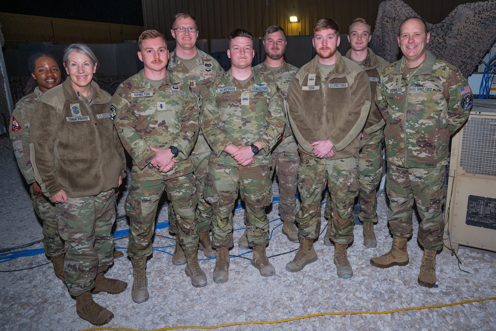 Military members stand in a group
