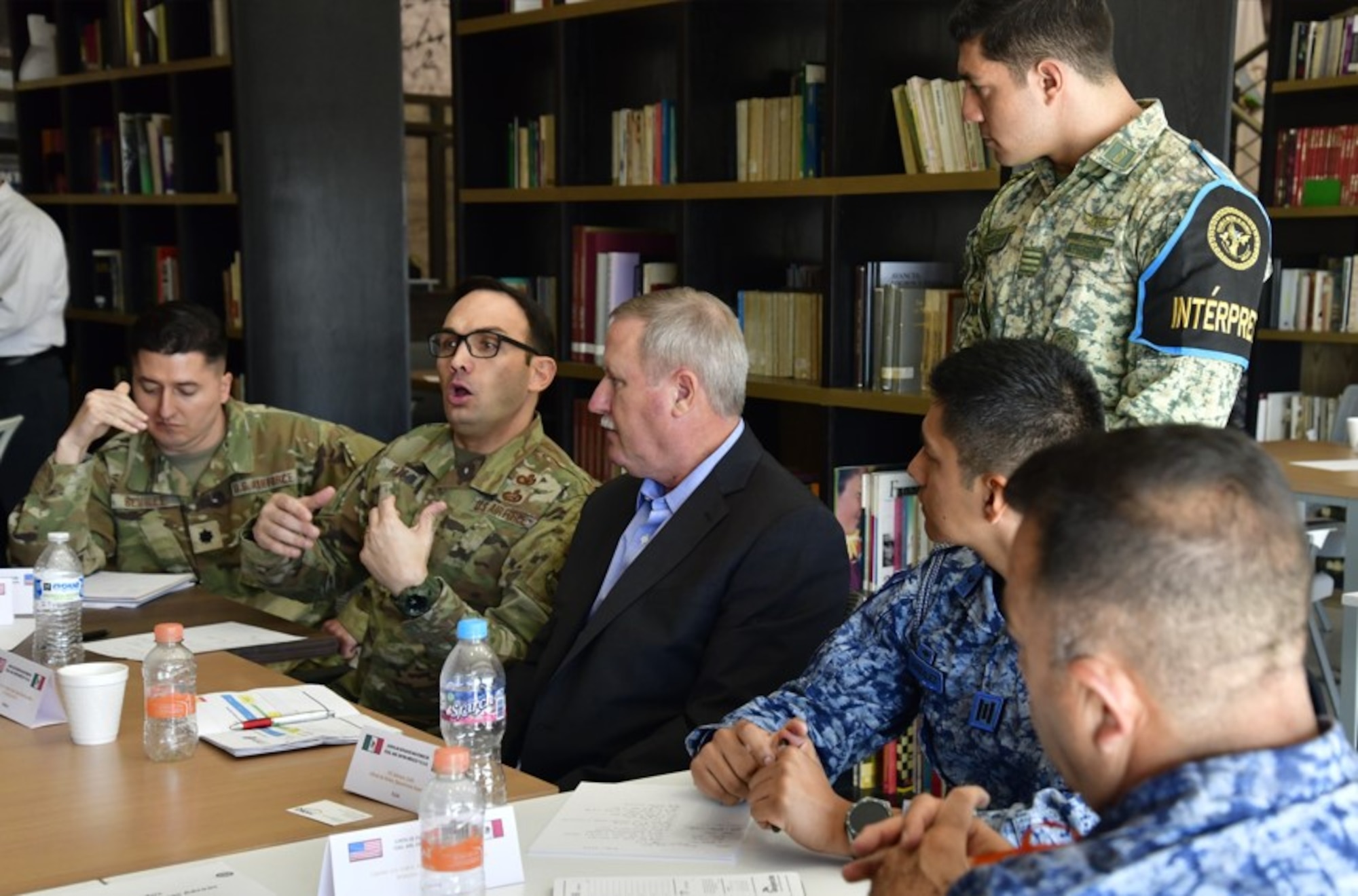 U.S. and Mexican Air Force participants sitting at a table, discussing how to strengthen their collaboration and tackle shared challenges at the 2024 Air Force Staff Talks (AFST) between the US and Mexican Air Forces.