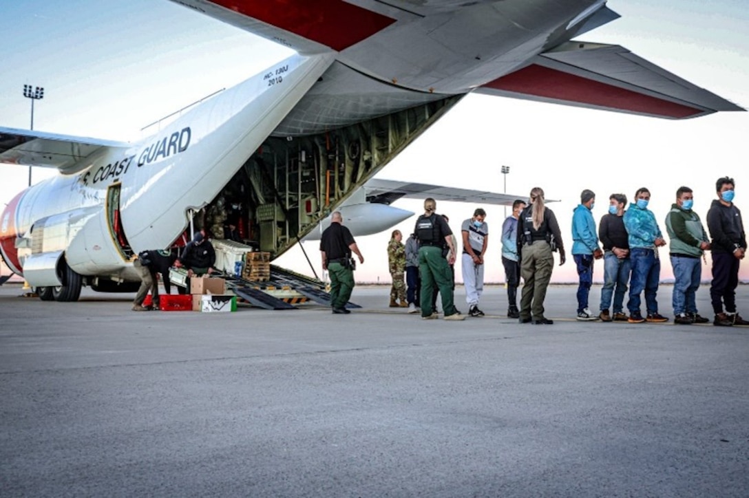 U.S. Coast Guardsmen assigned to tactical law enforcement teams work alongside U.S. Customs and Border Protection personnel to facilitate the disembarkation of aliens from a Coast Guard HC-130 Hercules airplane in El Paso, Texas, Feb. 2, 2025. Alien expulsion flights continue the Coast Guard’s actions to enforce the immigration laws of the U.S. in accordance with the president’s executive orders. (U.S. Coast Guard photo, courtesy Air Station Barbers Point)