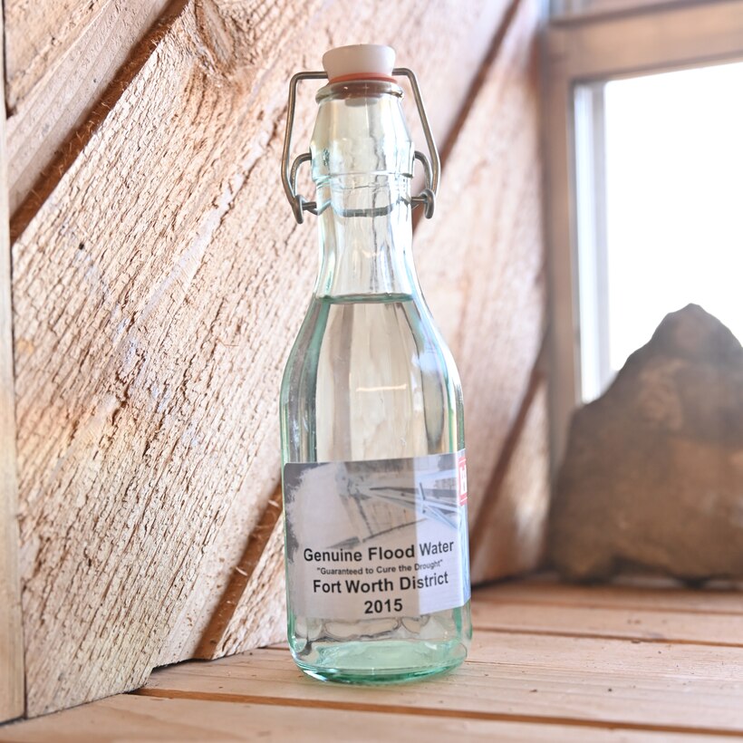 James Thompson, the lake manager for Fort Worth District’s Hords Creek and O.C. Fisher lakes, was presented with a bottle of “Genuine Flood Water” from O.C. Fisher in 2015. It was meant as an award for the lake within the Fort Worth District that prevented the highest estimated amount of damage during that year. One night in May 2015 the North Concho River rose over 22 feet. The estimated amount of damages that might have occurred during that rain event, had the dam not been present, is $5 million.