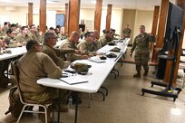 Capt. Nicole Barela-Vess, right, a Warfighter project officer with the 213th Regional Support Group, conducts an in-processing briefing for participants in a Warfighter exercise Jan. 16, 2025, at Fort Indiantown Gap, Pa. (Pennsylvania National Guard photo by Brad Rhen)