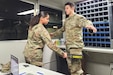 Soldiers from the 213th Regional Support Group practice using a hand-held metal detector at an entry-control point during a Warfighter exercise at Fort Indiantown Gap. More than 100 Soldiers from the 213th RSG provided real-life support for the exercise. (Courtesy photo)