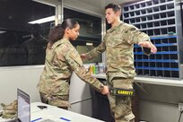 Soldiers from the 213th Regional Support Group practice using a hand-held metal detector at an entry-control point during a Warfighter exercise at Fort Indiantown Gap. More than 100 Soldiers from the 213th RSG provided real-life support for the exercise. (Courtesy photo)