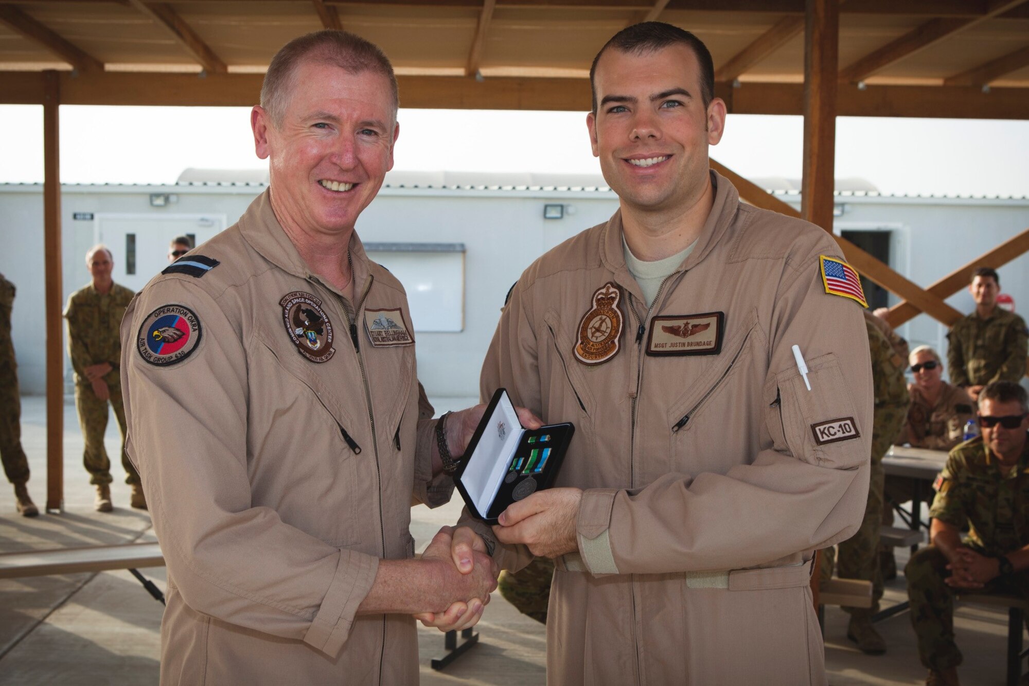 U.S. Air Force Master Sgt. Justin Brundage is awarded the Australian Operational Service Medal - Greater Middle East Operation by Royal Australian Air Force (RAAF) Air Commodore Stuart Bellingham at Al Dhafra Air Base, United Arab Emirates, June 2, 2017. Out of more than 60 applicants, Brundage was selected to represent the U.S. Air Force as an international affairs Airman in the RAAF. (courtesy photo)
