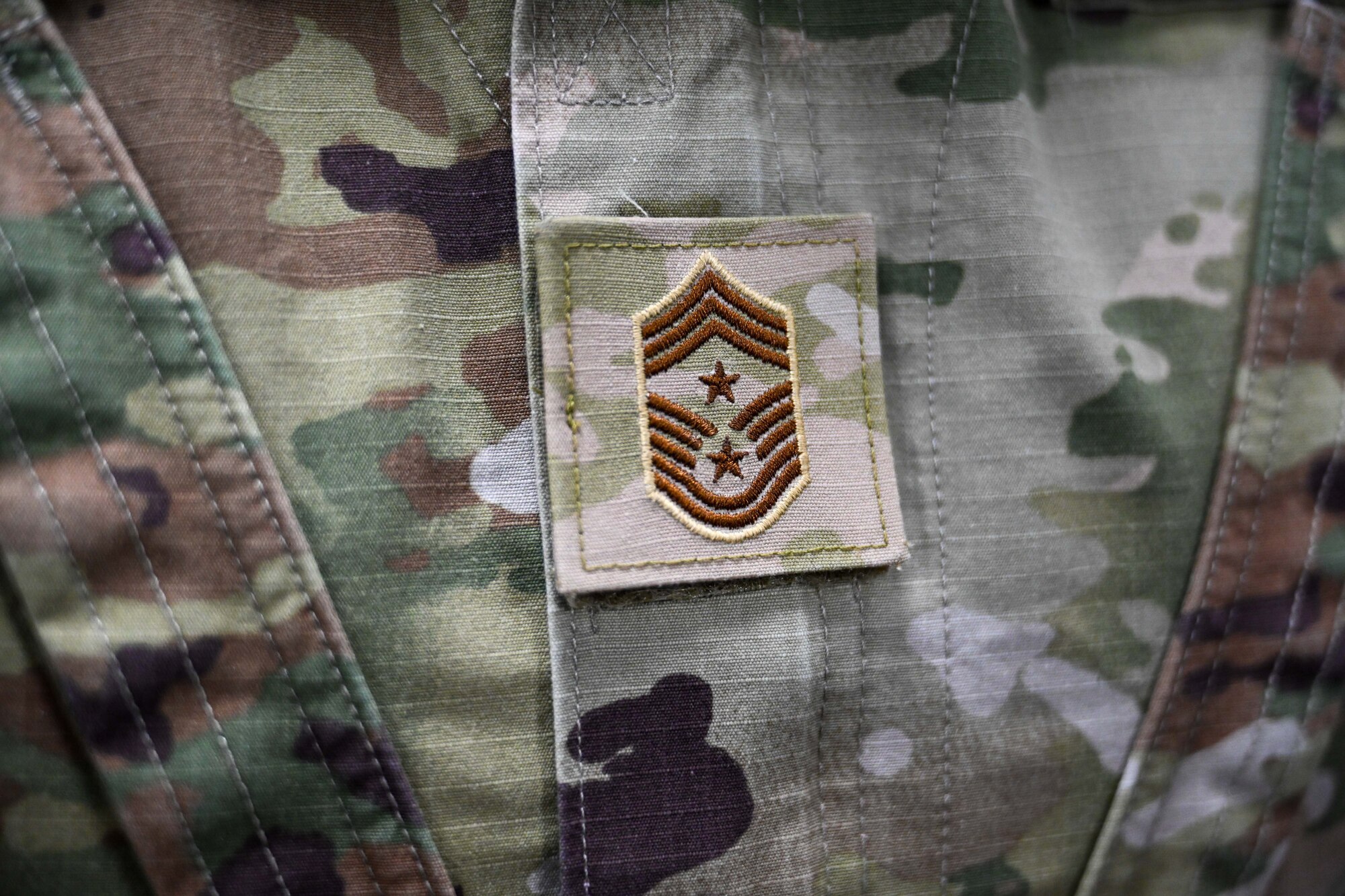 The rank of a U.S. Air Force Command Chief Master Sgt. is displayed on the uniform of Chief Master Sgt. Justin Brundage, 97th Air Mobility Wing command chief, at Altus Air Force Base, Oklahoma, Jan. 28, 2025. Command chiefs serve as the principal enlisted advisor to the commander at the wing level or higher. (U.S. Air Force Photo by Airman 1st Class Jonah Bliss)