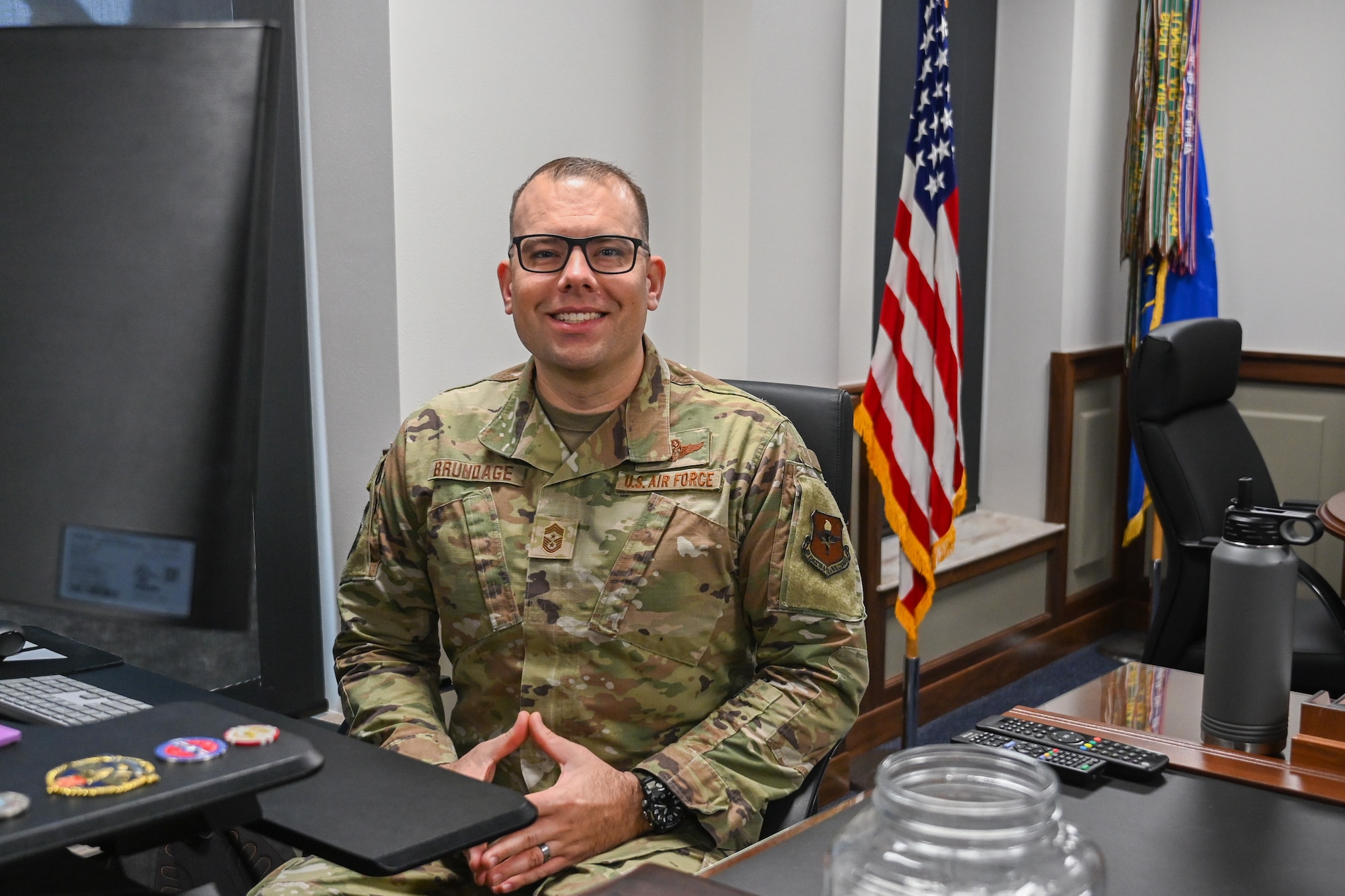 U.S. Air Force Chief Master Sgt. Justin Brundage , 97th Air Mobility Wing command chief, poses for a photo at his desk at Altus Air Force Base, Oklahoma, Jan. 28, 2025. Brundage has served in the Air Force for 23 years, closing his career as a wing level command chief. (U.S. Air Force Photo by Airman 1st Class Jonah Bliss)