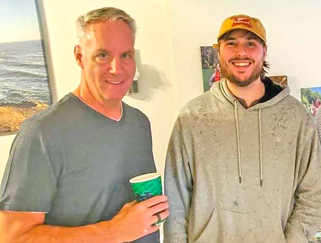Two men pose for a photo.