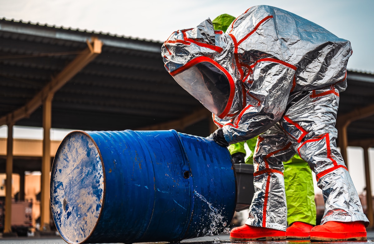 U.S. Air Force Senior Airman Jonathan Cain, 379th Expeditionary Civil Engineer Squadron fire protection firefighter, inspects a simulated hazardous materials leak within the U.S. Central Command area of responsibility, Jan. 30, 2025. Airmen mitigated the leak and decontaminated the area, practicing different scenarios to enforce proper safety procedures. (U.S. Air Force photo by Airman 1st Class Zeeshan Naeem)