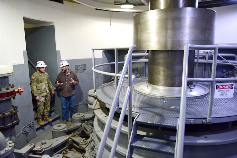 Chris Marlow (Left), U.S. Army Corps of Engineers Nashville District's Power Project manager in Eastern Kentucky, accompanies USACE Command Sgt. Maj. Douglas Galick Feb. 11, 2025, to see a turbine in the Wolf Creek Dam Powerhouse. The project is located on the Cumberland River in Jamestown, Kentucky. It generates hydroelectricity and reduces flood risk by storing water in Lake Cumberland. (USACE Photo by Lee Roberts)