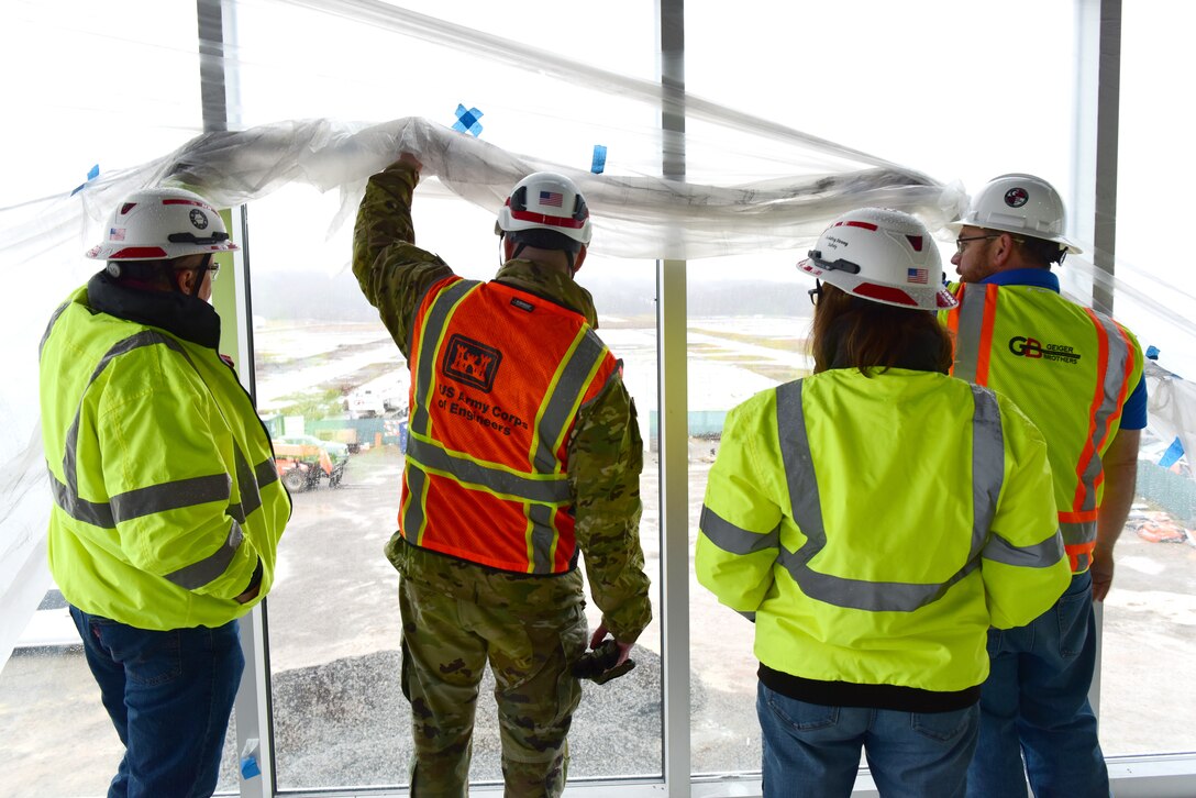 U.S. Army Corps of Engineers Command Sgt. Maj. Douglas Galick (red safety vest) checks out the view during a tour Feb. 12, 2025, of ongoing construction of the K-25 Viewing Platform Building at East Tennessee Technology Park in Oak Ridge, Tennessee. The Nashville District is managing construction for the U.S. Department of Energy’s Oak Ridge Office of Environmental Management. The building will provide a historic lookout over the footprint of where the K-25 Building once stood, and the Oak Ridge Diffusion Plant produced uranium during World War II as part of the Manhattan Project. (USACE Photo by Lee Roberts)