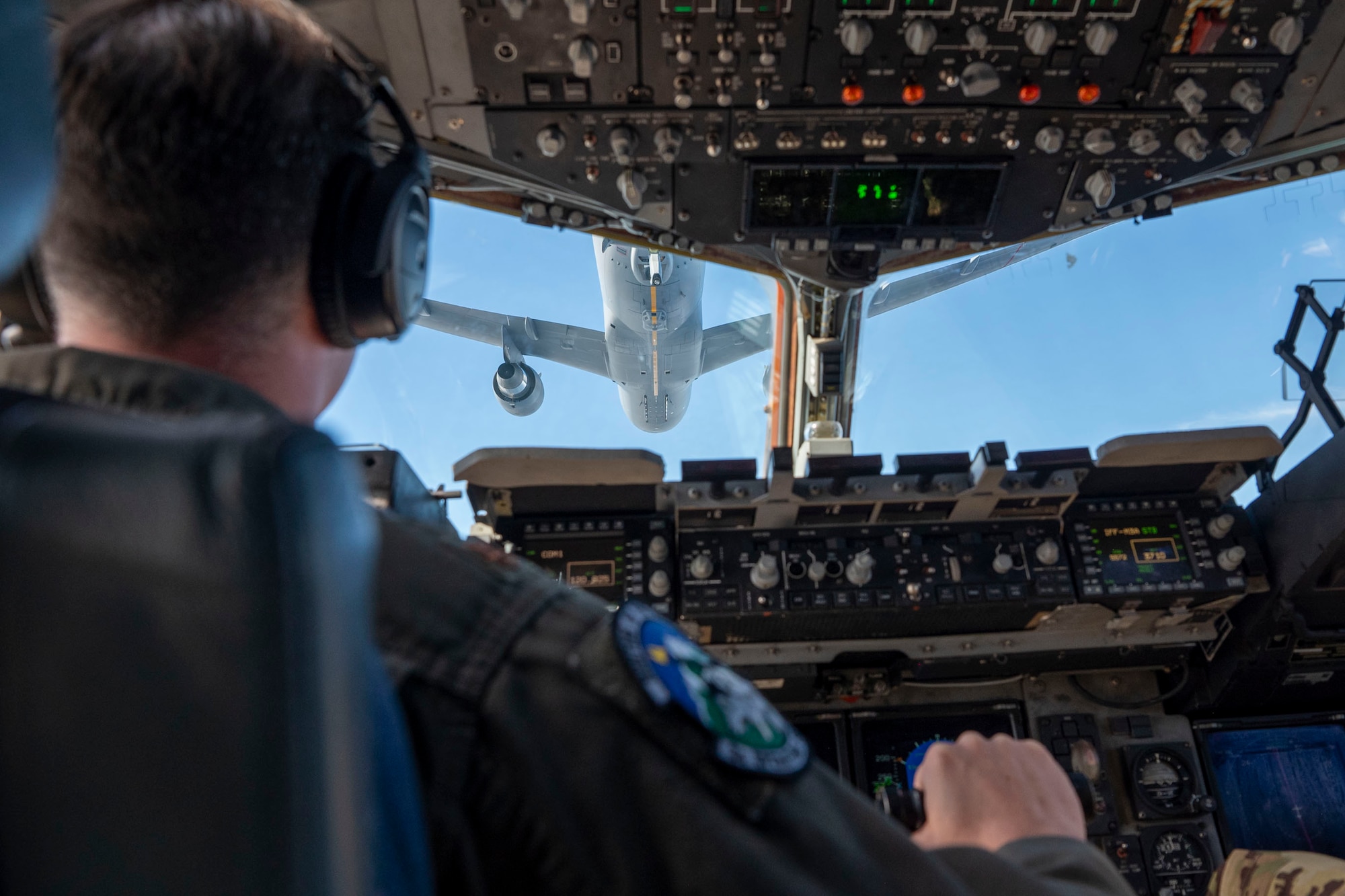 A U.S. Air Force pilot assigned to the 517th Airlift Squadron from Joint Base Elmendorf lines up a C-17 Globemaster III from Joint Base Lewis-McChord, Washington, for low-altitude aerial refueling with a KC-46 Pegasus assigned to 305th Air Mobility Wing from Joint Base McGuire-Dix-Lakehurst , in the Pacific region, Feb. 11, 2025.
