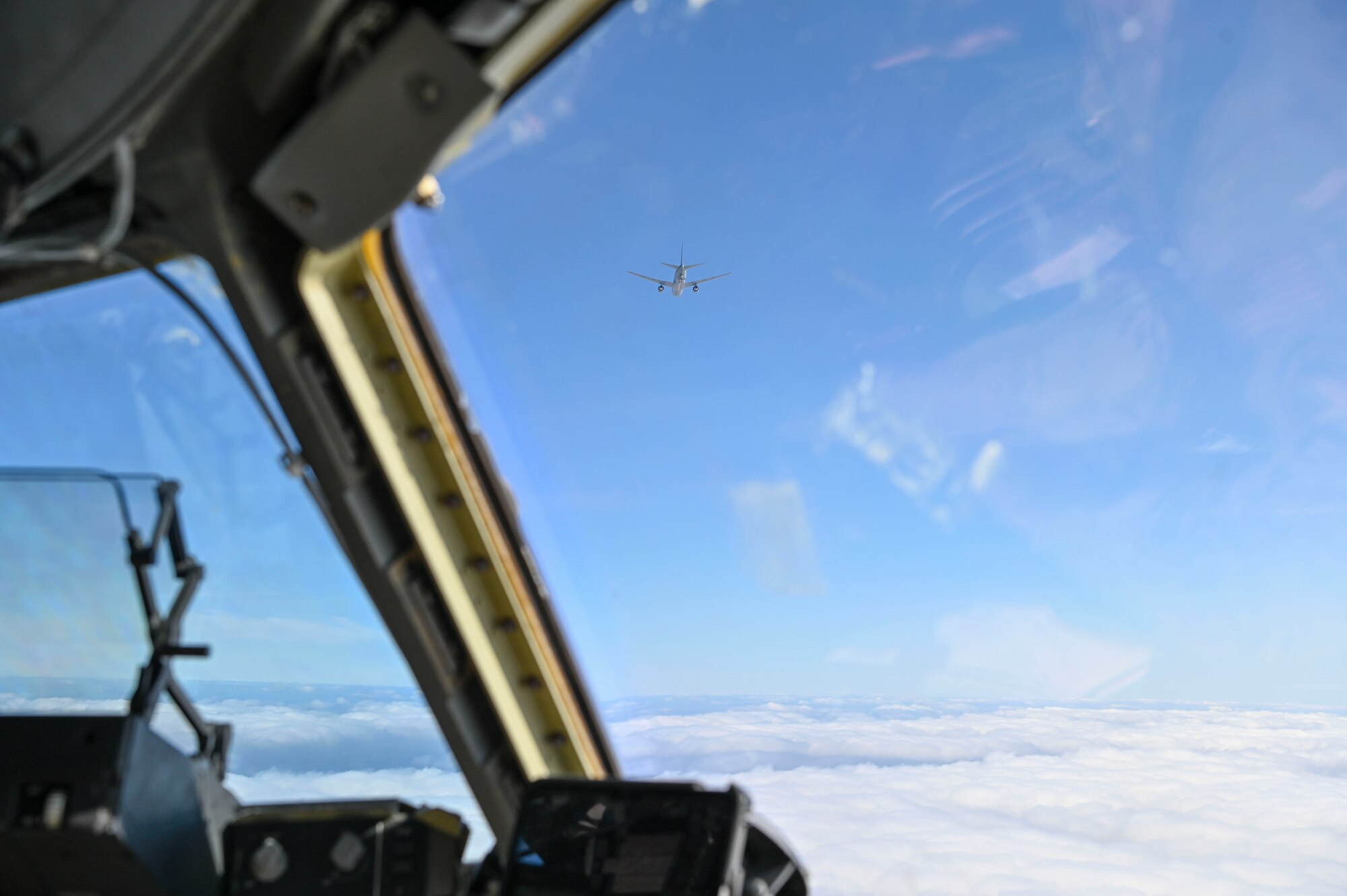 A KC-46 Pegasus assigned to the 305th Air Mobility Wing from Joint Base McGuire-Dix-Lakehurst flies near a C-17 Globemaster III assigned to the 7th Expeditionary Airlift Squadron at Joint Base Lewis-McChord, Washington, during Bamboo Eagle 25-1 in the Pacific region, Feb. 11, 2025.
