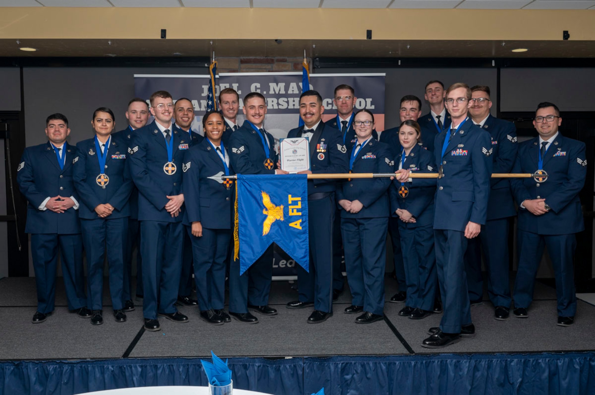 Airmen in the Warrior Flight accepts the Honor Flight award during the graduation of Joel C. Mayo ALS Class 25-B at Holloman Air Force Base, New Mexico, Feb. 7, 2025. The Honor Flight award recognizes the flight that demonstrated the utmost professionalism, motivation and fitness standards throughout the course. (U.S. Air Force photo by Senior Airman Michelle Ferrari)