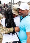 An Airman hugs family members following the 737th Training Group Coin and Retreat Ceremony