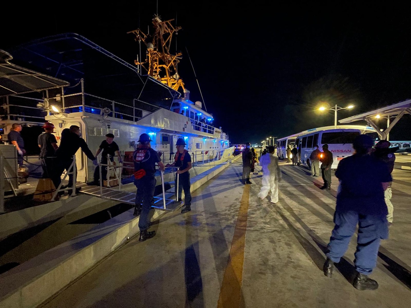 The crew of the Coast Guard Cutter Margaret Norvell transferring interdicted aliens to Bahamian authorities, Feb. 14, 2025. A total of 31 aliens were repatriated in Nassau. (U.S. Coast Guard photo)