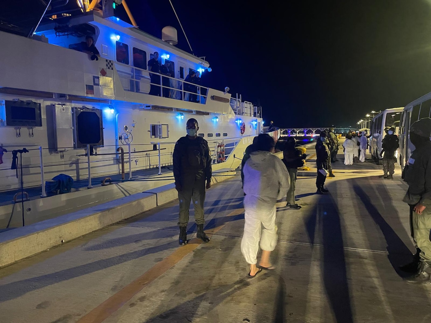 The crew of the Coast Guard Cutter Margaret Norvell transferring interdicted aliens to Bahamian authorities, Feb. 14, 2025. A total of 31 aliens were repatriated in Nassau. (U.S. Coast Guard photo)