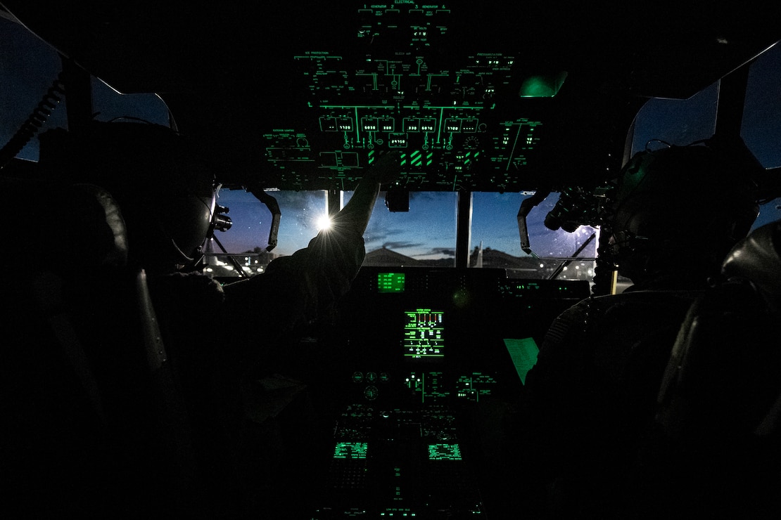 U.S. Air Force Capts. Zachary Norton and Steven Gilliam, 36th Airlift Squadron C-130J pilots, conduct a pre-flight check before conducting a night sortie at Yokota Air Base, Japan, Feb. 6, 2025.