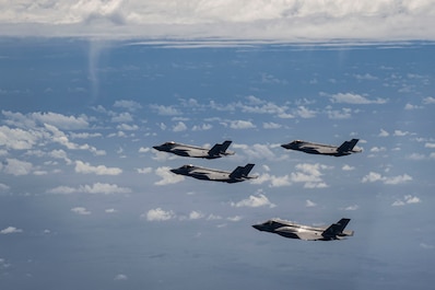 ANDERSEN AFB, Guam (Feb. 7, 2025) — A U.S. Air Force F-35A Lightning II is flanked from top to bottom by a Royal Australian Air Force F-35A, a Japan Air Self Defense Force F-35A and a U.S. Marine Corps F-35B Lightning II during a formation over the U.S. Indo-Pacific Command area of responsibility, Feb. 7, 2025, as part of exercise Cope North 2025. The F-35A provides next-generation stealth, enhanced situational awareness, and reduced vulnerability to the realistic combat training and scenarios in CN25. The aircraft participating in CN25 engage in realistic combat training, an essential part of ensuring the success of air and space operations. (U.S. Air Force photo by Airman 1st Class Thomas Hansford)