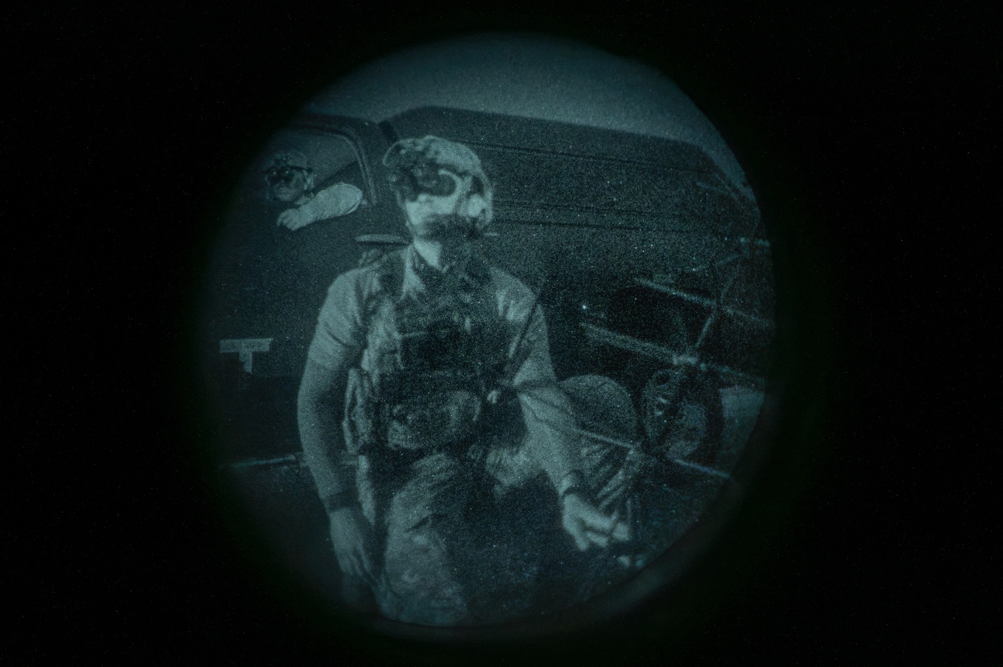 Airman kneels at night