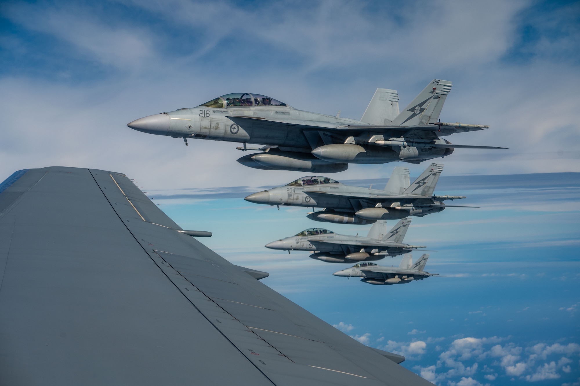 four airplanes flying outside a window