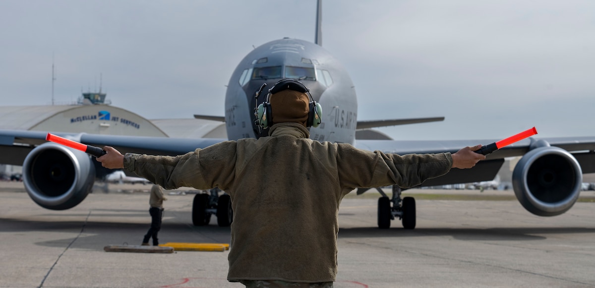 Man in front of airplane