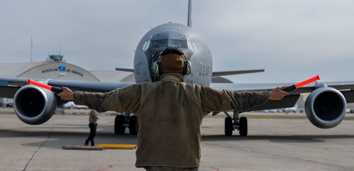 Man in front of airplane