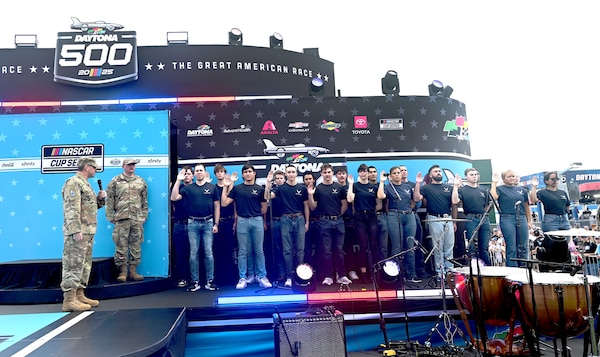 Air and Space Force members stand on a stage.