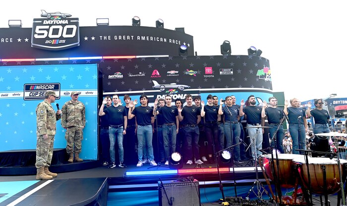 Air and Space Force members stand on a stage.