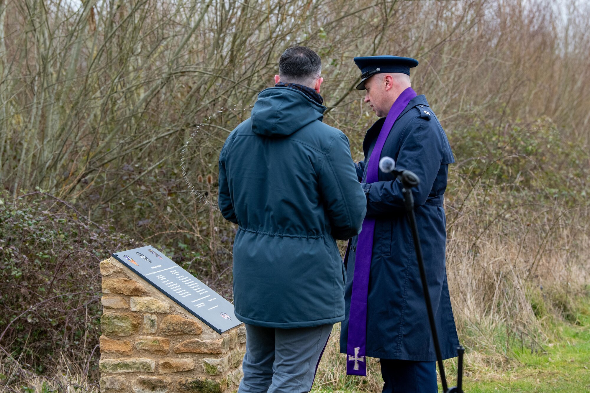 A Chaplain blesses a permanent memorial during a memorial ceremony