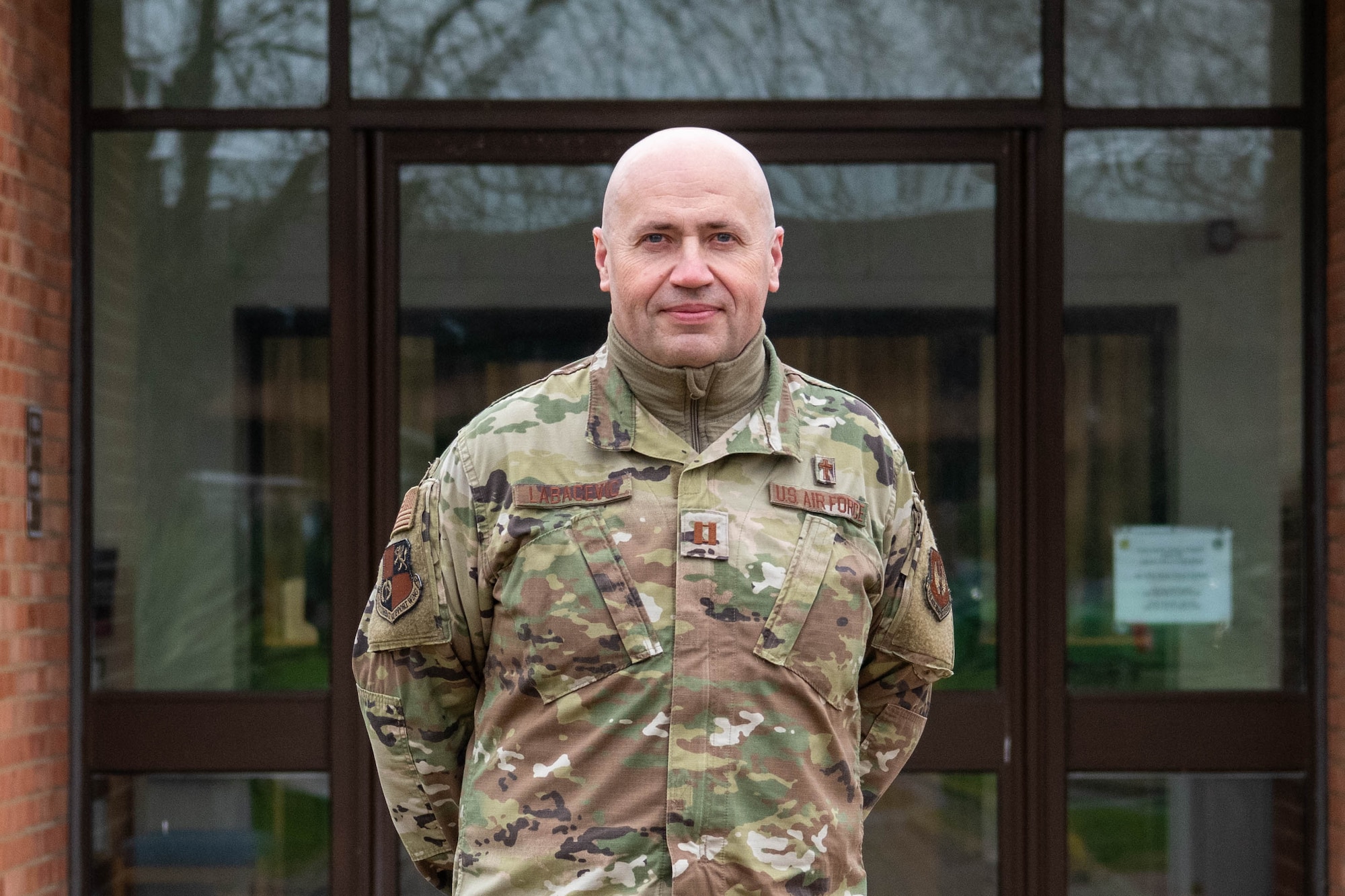 A Chaplain poses for a photo outside of the base chapel