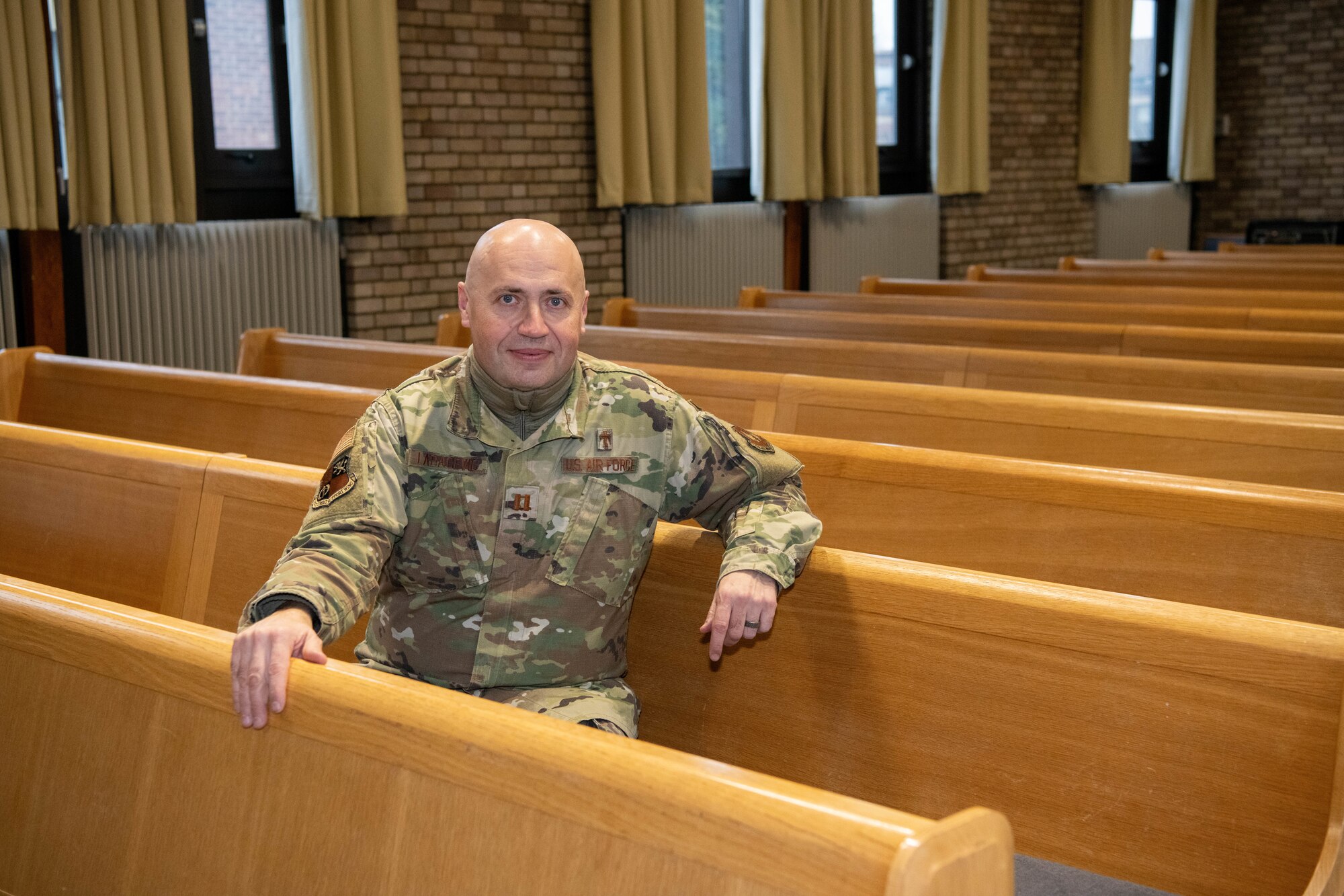A Chaplain poses for a photo inside of the base chapel