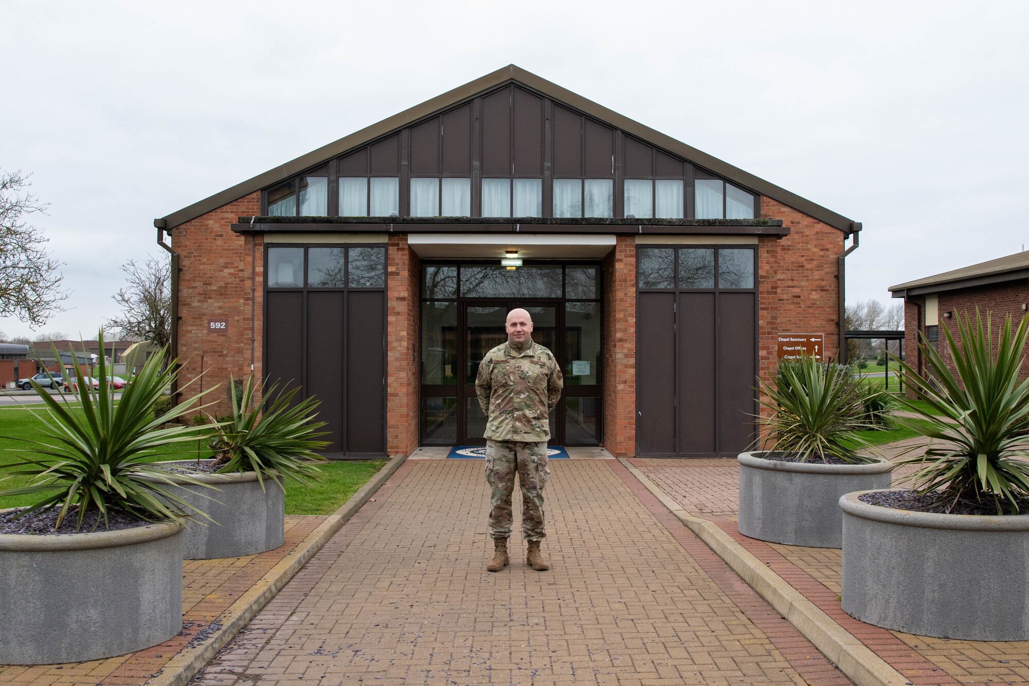 A Chaplain poses for a photo outside of the base chapel