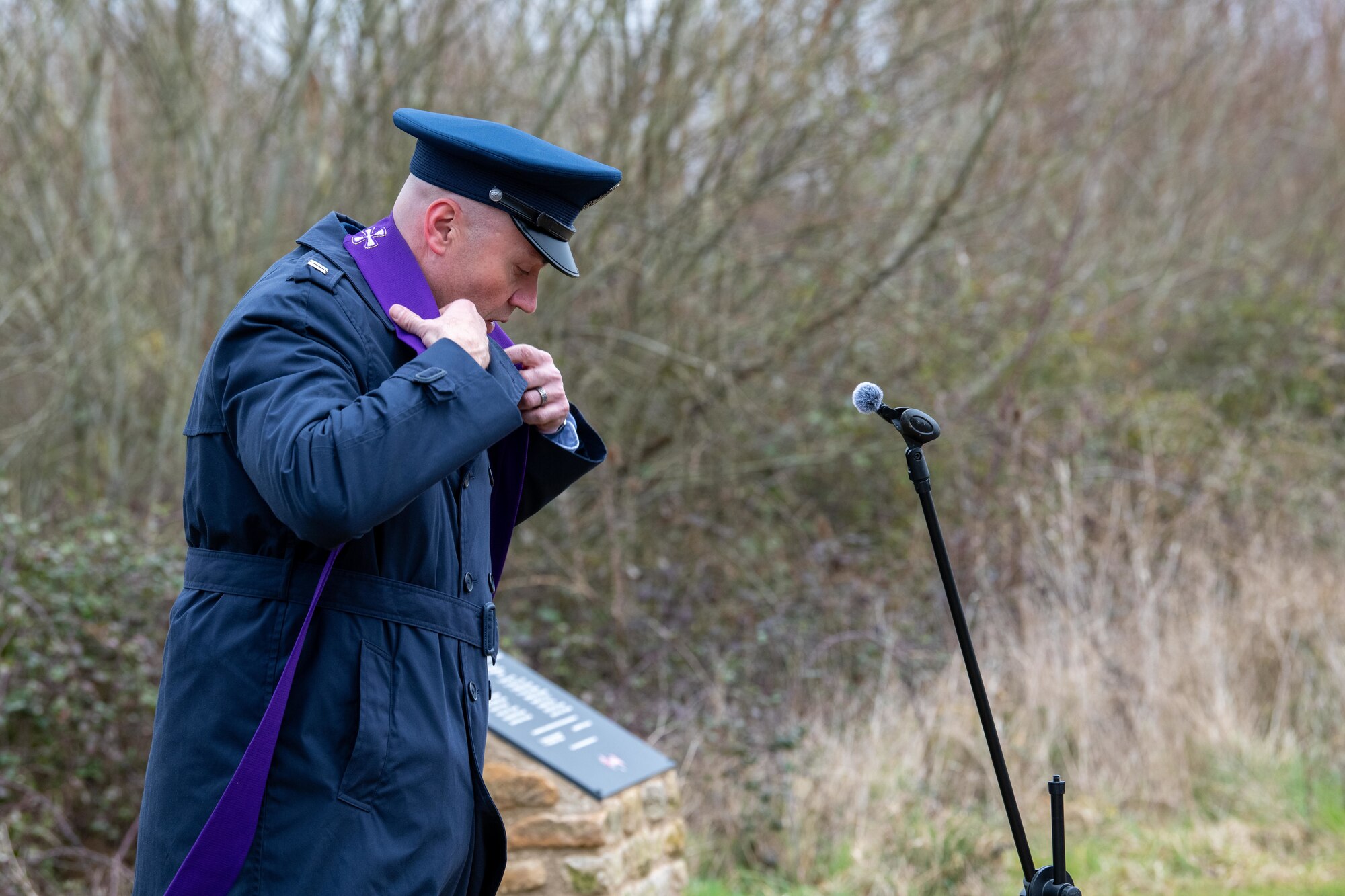 A Chaplain dons a stole during a memorial ceremony