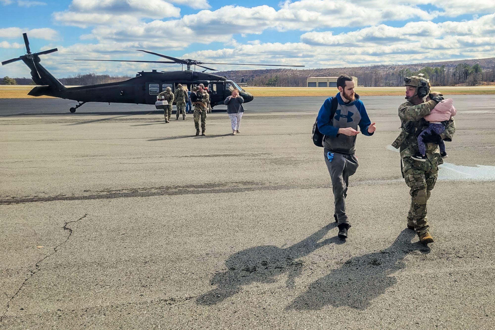 Airmen from the Kentucky Air National Guard’s 123rd Contingency Response Group receive flood victims arriving at the Big Sandy Regional Airport in Debord, Kentucky, Feb. 17, 2025. The evacuees were airlifted aboard Kentucky and Indiana Army National Guard helicopters from housing complexes in Martin County, Kentucky, that were surrounded by floodwaters. (U.S. Air National Guard photo by Master Sgt. Kyle Goins)