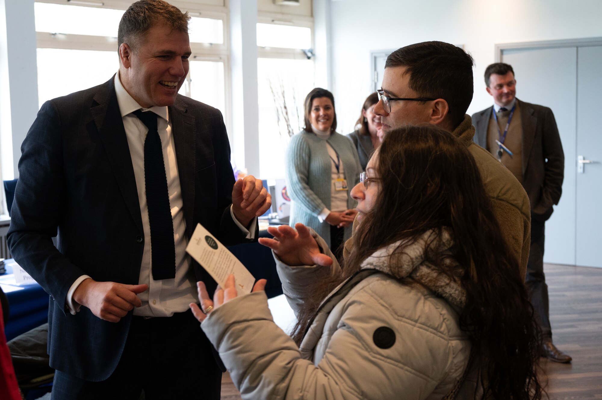Parents speak to a representative from a local school