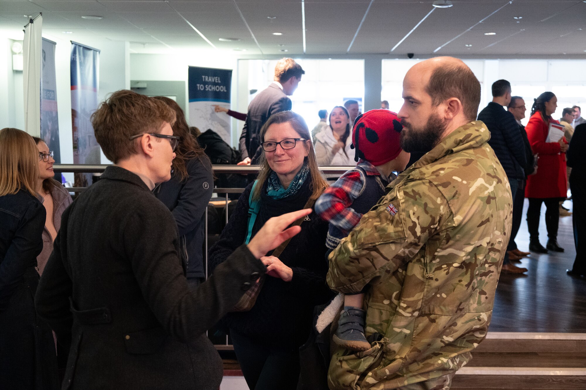Parents speak to a representative from a local school