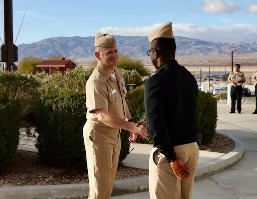 NMRTC Twentynine Palms Commanding Officer Capt. Daniel Clark (left) congratulates Chief Informatics Officer Lt. Emmanuel Dadzie (right) on February 7, 2024, after Dadzie was named Navy Medicine’s 2024 Junior Health Information Technology Officer of the Year. As the Chief Informatics Officer at NMRTC Twentynine Palms, Dadzie was recognized for his leadership in modernizing the command’s IT infrastructure and successfully integrating the Military Health System (MHS) Genesis electronic health record into field operations. His efforts have significantly enhanced medical support for operational forces aboard Marine Corps Air Ground Combat Center Twentynine Palms, ensuring healthcare providers can access critical patient data in real time, even in austere environments (U.S. Navy photo by Christopher C. Jones, NHTP/NMRTC Twentynine Palms public affairs officer).