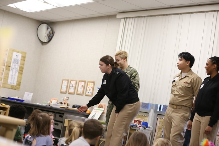 Lt. Hannah Mills, a Naval Health Clinic Lemoore dentist teaches preschool students at Admiral Akers School about good food choices for their teeth and how to keep their teeth clean. (U.S. Navy photo by Elaine Heirigs Naval Health Clinic Lemoore/Navy Medicine Readiness and Training Command Lemoore Public Affairs)
