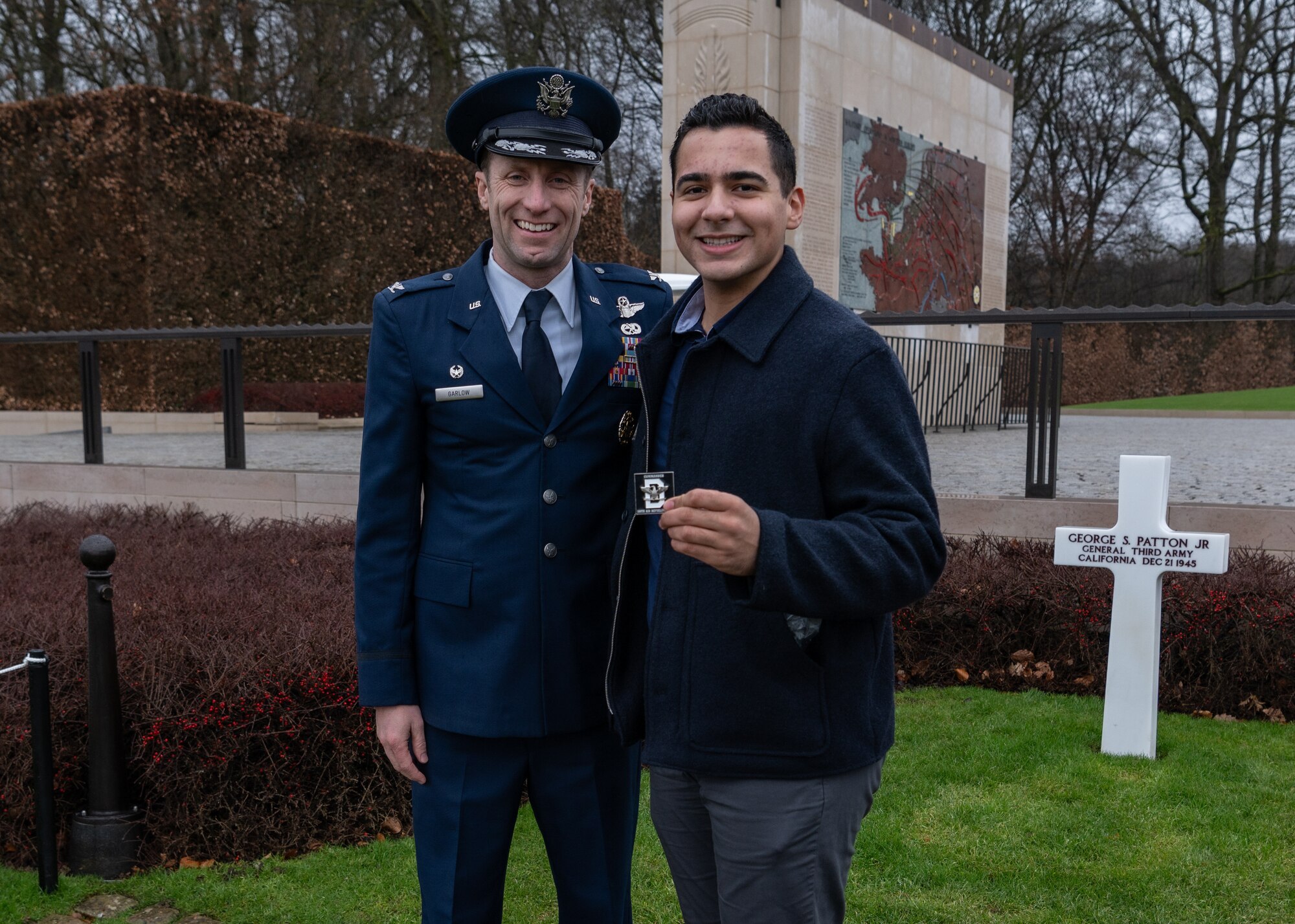 U.S. Air Force Col. Ryan Garlow, left, 100th Air Refueling Wing commander, and Airman 1st Class Aidan Martinez, 100th ARW Public Affairs specialist, pose for a photo at the Luxembourg American Cemetery, Hamm, Luxembourg, Jan. 25, 2025.