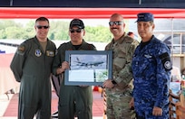From left, Col. Nelson Perron, commander of the 157th Air Refueling Wing, New Hampshire National Guard; Col. Pablo Soriano, chief of staff of the Salvadoran Air Force; Chief Master Sgt. Kevin Reiter, command chief of the 157th ARW, and Col. Rafael Melara, commander of the Salvadoran Air Force Academy, exchange gifts at the Ilopango Air Show in El Salvador Feb.1.