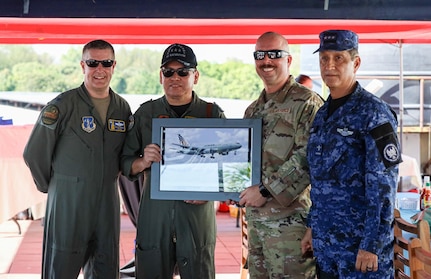 From left, Col. Nelson Perron, commander of the 157th Air Refueling Wing, New Hampshire National Guard; Col. Pablo Soriano, chief of staff of the Salvadoran Air Force; Chief Master Sgt. Kevin Reiter, command chief of the 157th ARW, and Col. Rafael Melara, commander of the Salvadoran Air Force Academy, exchange gifts at the Ilopango Air Show in El Salvador Feb.1.