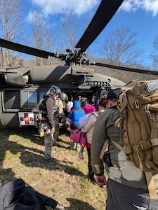 Airmen from the Kentucky Air National Guard’s 123rd Special Tactics Squadron evacuate 296 stranded residents from two housing complexes surrounded by floodwaters in Martin County, Kentucky, Feb. 17, 2025. The residents were flown to the Big Sandy Regional Airport in Debord aboard UH-60 Black Hawk helicopters from the Indiana Army National Guard and the Kentucky Army National Guard’s 63rd Theater Aviation Brigade.