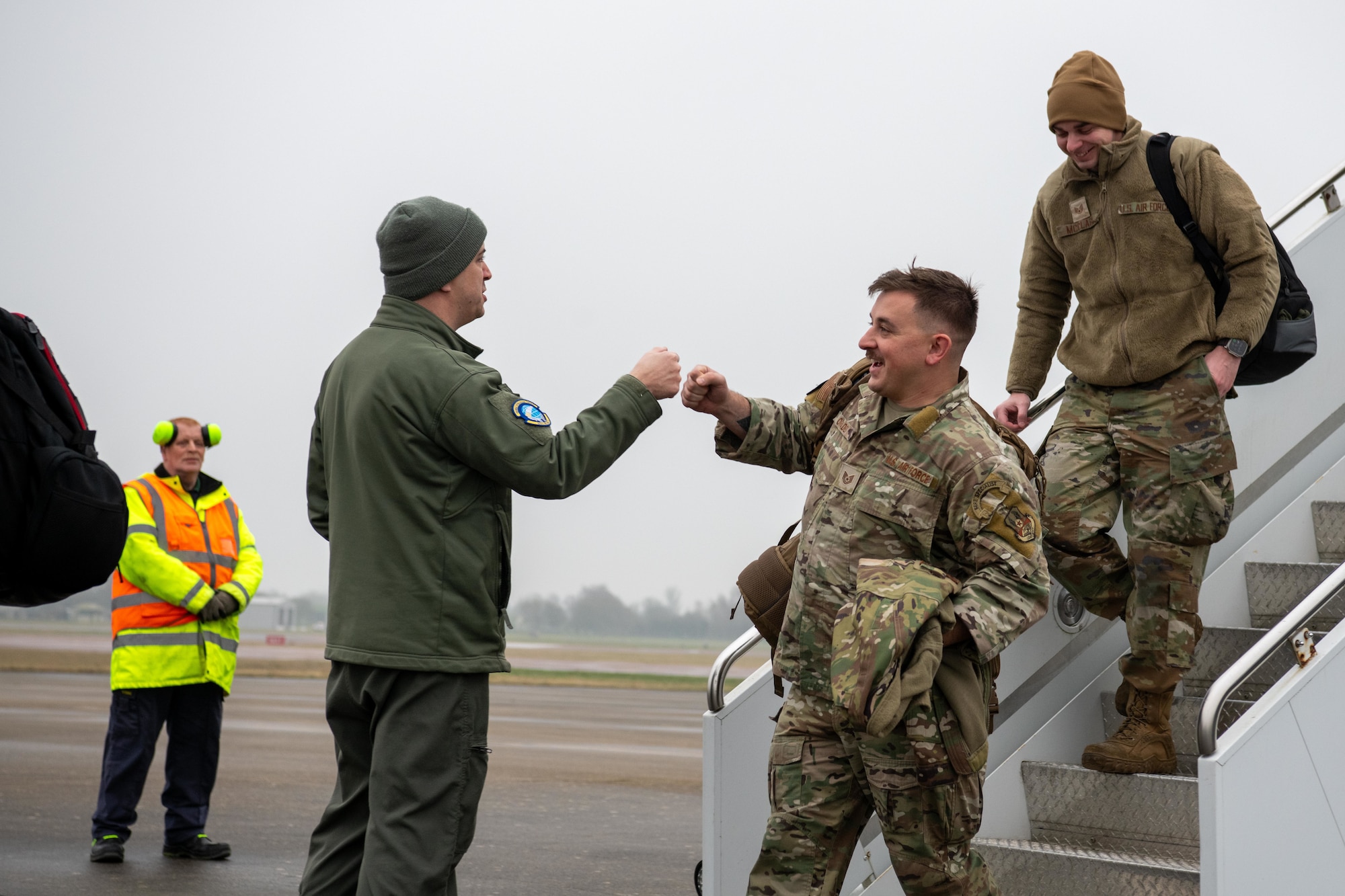 A leader greets Airmen as they exit an Atlas Air Boeing 767 aircraft