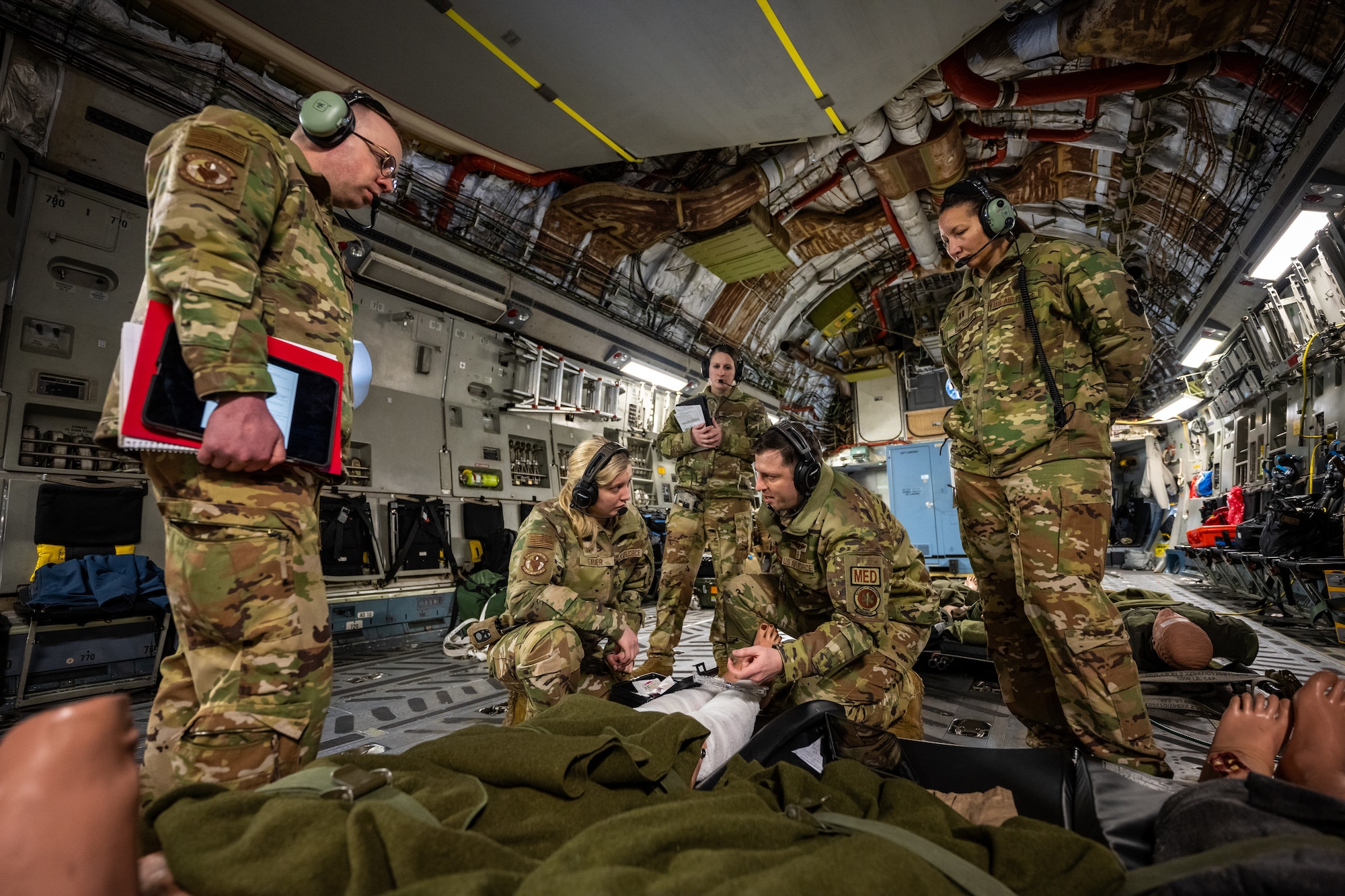 Members of the 445th Aeromedical Evacuation Squadron run through a training scenario during an AE training flight onboard a C-17 Globemaster III recently. The training consisted of transporting injured or sick patients on military aircraft during simulated combat or emergency situations. (U.S. Air Force photo/Daniel Peterson)
